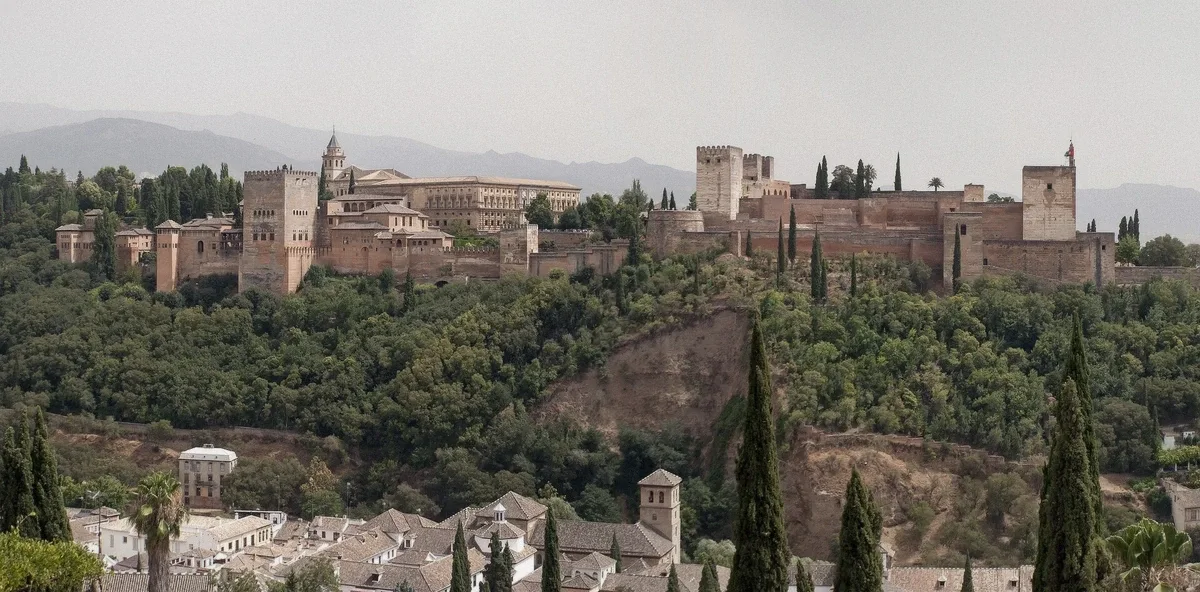 The Alhambra palace complex seen across the valley with the city below, Granada, Spain