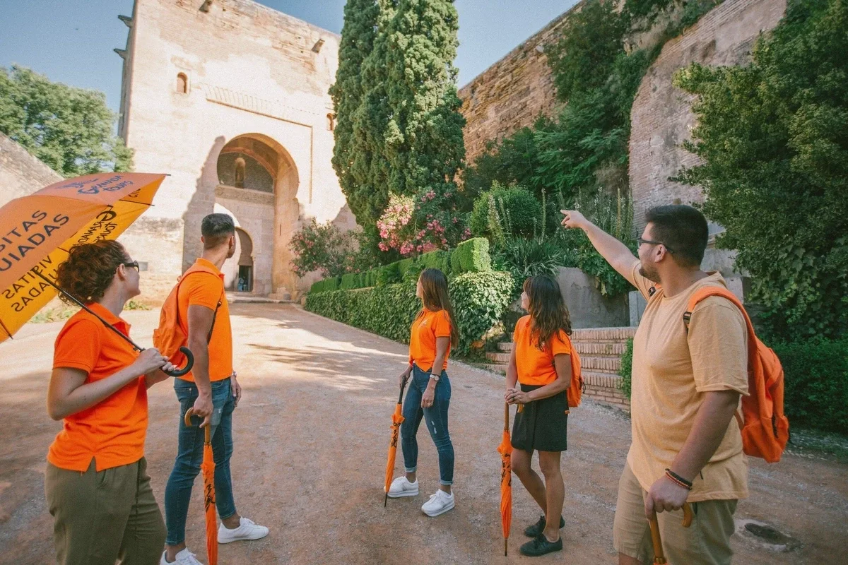 Guided group with headsets walking through the Alhambra in Granada, Spain