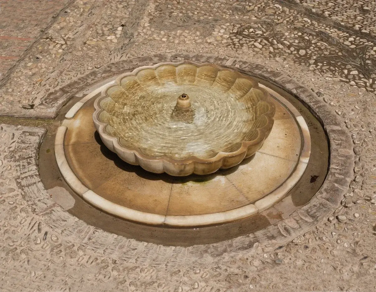 Fountain and clipped hedges in the Generalife gardens at the Alhambra, Granada