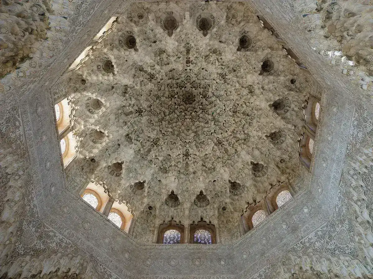 Carved stucco wall with arabesque patterns inside the Nasrid Palaces, Alhambra, Granada