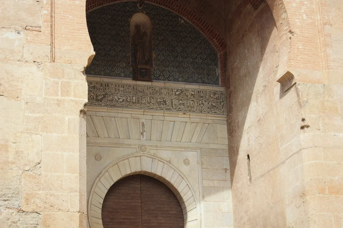 Travellers entering the Alhambra justice gate with a private skip-the-line guide in Granada, Spain