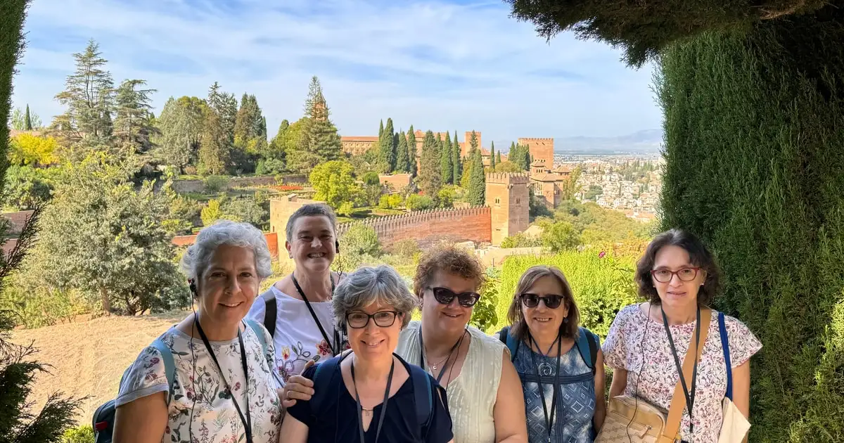 Private guide leading a group through the Generalife gardens on a full private Alhambra tour in Granada, Spain